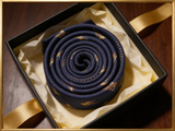 The Windsor Mallard Silk Tie rolled in a gift box, close detail of the silk weave