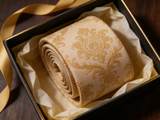 The Westminster Gold Damask Silk Tie rolled in a gift box, close detail of the silk weave