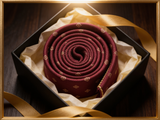 The St. James Medallion Silk Tie rolled in a gift box, close detail of the silk weave