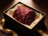 The Kingsway Heraldic Silk Tie rolled in a gift box, close detail of the silk weave