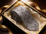 The Balmoral Falcon Silk Tie rolled in a gift box, close detail of the silk weave