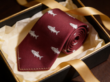 The Speyside Salmon Silk Tie rolled in a gift box, close detail of the silk weave
