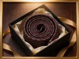 The Westminster Burgundy Basketweave Tie rolled in a gift box, close detail of the silk weave