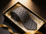 The Shard Geometric Prism Tie rolled in a gift box, close detail of the silk weave