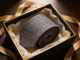 The Bond Textured Grenadine Tie rolled in a gift box, close detail of the silk weave