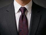 Heritage Paisley Tie worn in a four-in-hand knot with a white collar and charcoal suit