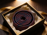 Heritage Paisley Tie rolled in a gift box, close detail of the silk weave