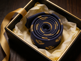 Royal Oak Navy & Gold Tie rolled in a gift box, close detail of the silk weave