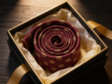 Sovereign Burgundy Rosette Tie rolled in a gift box, close detail of the silk weave