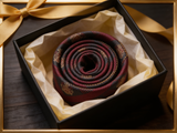 Crested Regimental Charcoal & Crimson Tie rolled in a gift box, close detail of the silk weave