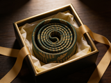 Sherwood Houndstooth Oak Tie rolled in a gift box, close detail of the silk weave