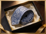 Floral Brocade Navy & Silver Tie rolled in a gift box, close detail of the silk weave