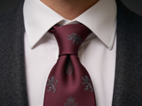 Windsor Crest Burgundy Tie worn in a four-in-hand knot with a white collar and charcoal suit
