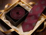 Windsor Crest Burgundy Tie rolled in a gift box, close detail of the silk weave